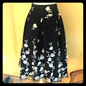 Navy blue tulle skirt with white flowers.